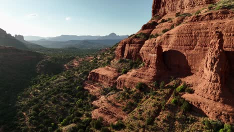 Luftaufnahme-Des-Roten-Felsens-Am-Berghang-Des-Grünen-Waldes-In-Sedona,-Arizona