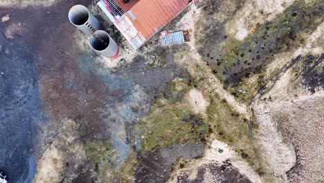 Abandoned-Iceland-farm-reclaimed-by-nature,-drone-footage-shows-decayed-buildings-and-silos-amidst-dry-grass