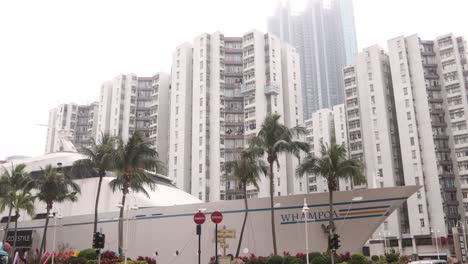 Cruise-Ship-Docked-Next-to-Modern-Condominium-Buildings-In-Residential-Area-In-Hong-Kong,-Panning-View