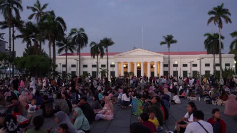 Crowd-gathers-at-Taman-Fatahillah,-a-popular-tourist-spot-in-Jakarta,-during-twilight