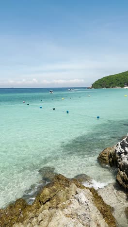 Crystal-clear-water-of-a-Thailand-beach-is-visible-and-the-board-is-also-visible