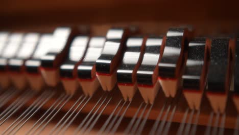 a-detail-cinematic-shot-of-the-hammer-mechanism-of-a-piano-in-motion