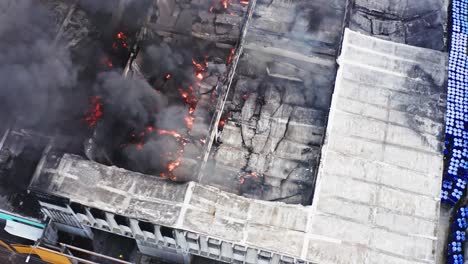 Factory-explosion-leaves-flames,-smoke,-and-collapsed-roof