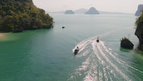 4K-aerial-drone-footage-of-longtail-boats-in-Thailand,-comming-to-the-beach,-Asia,-Andaman-sea,-Pakbia-Island