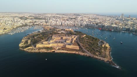 Drone-flight-around-island-in-Malta-at-sunrise