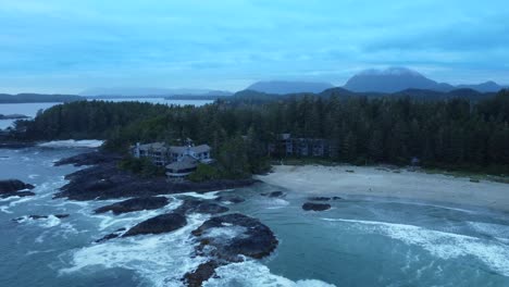 Holiday-villa-on-Tofino-coast-Vancouver-Island,-Canada,-aerial-evergreen-tree-forest