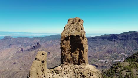 Aerial-view-of-people-hiking-in-Gran-Canaria-at-Roque-Nublo-mountain-geologic-rock-formation