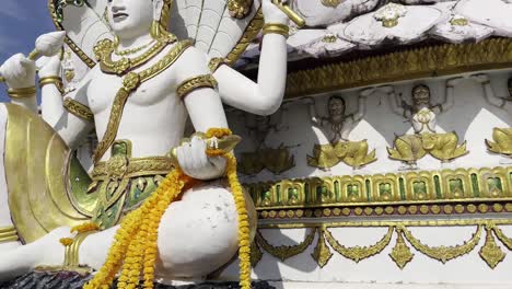 Wat-Plai-Laem-Temple-buddhist-in-Koh-Samui-Island-Thailand-big-buddha-close-up-tilt-up