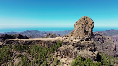 Aerial-view-of-people-hiking-in-Gran-Canaria-at-Roque-Nublo-mountain-geologic-rock-formation