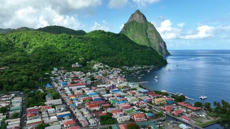 Aerial-establishing-shot-of-Colorful-Soufriere-City-and-idyllic-green-mountain-landscape-in-St