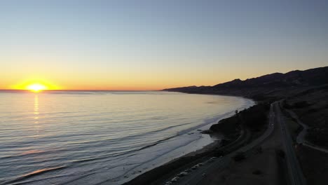 Imágenes-De-Drones-Al-Atardecer-De-Una-Carretera-Junto-Al-Océano-Pacífico-En-California