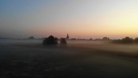 Village-surrounded-by-clouds-of-fog