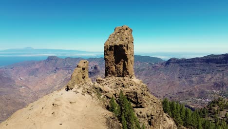 Aerial-view-of-people-hiking-in-Gran-Canaria-at-Roque-Nublo-mountain-geologic-rock-formation