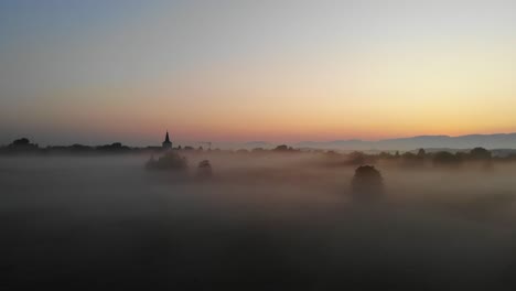 Timelapse-of-a-village-surrounded-by-clouds-of-fog