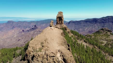 Aerial-view-of-people-hiking-in-Gran-Canaria-at-Roque-Nublo-mountain-geologic-rock-formation