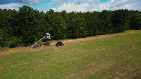 Aerial-Shot-of-Off-Road-vehicle-driving-by-deer-stand