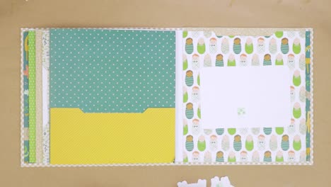 Decorating-scrapbook-album-with-die-cuts-and-stickers-for-a-baby-shower-gift