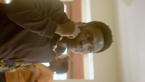 Vertical-Portrait-Of-An-African-American-Man-Having-Conversation-On-The-Smartphone