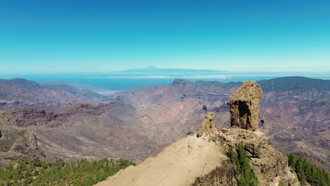 Aerial-view-of-people-hiking-in-Gran-Canaria-at-Roque-Nublo-mountain-geologic-rock-formation