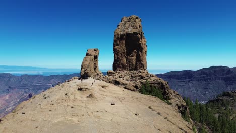 Aerial-view-of-people-hiking-in-Gran-Canaria-at-Roque-Nublo-mountain-geologic-rock-formation