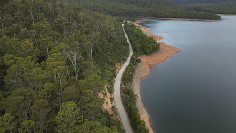 Rural-road-along-Huntsman-Lake,-Tasmania-in-Australia