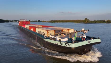 Ship-spotting-of-Te-Fiti,-container-vessel-sailing-at-netherlands-waters-panoramic-aerial-drone-morning-shot