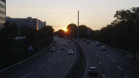 Three-lane-motorway-each-way,-Germany-fast-road,-view-of-cars-moving-at-sunset