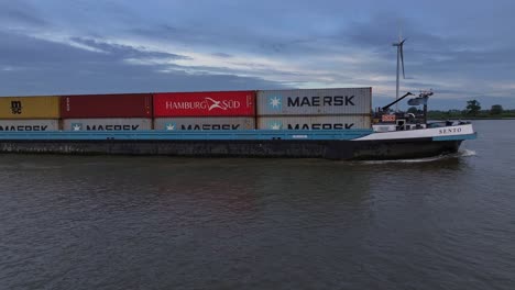 Cargo-ship-Sento-navigates-Oude-Maas-river,-passing-by-Barendrecht-in-Netherlands