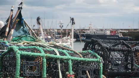 footage-of-Scarborough-fishing-harbour-with-crab-pots-and-boats-blurred-in-the-background,-North-Yorkshire-on-a-summer-day