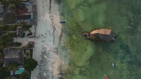 Top-view-of-The-Rock-Restaurant-with-beautiful-green-shoal-during-high-tide,-Zanzibar,-Tanzania