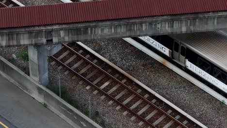 Aerial-view-of-metropolitan-Atlanta-train-approaching-Buckhead-Subway-station-through-Georgia-State-Route-400