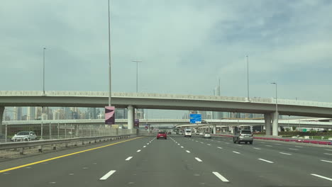 POV:-vehicles-driving-north-on-E11-multilane-freeway-in-Dubai,-UAE