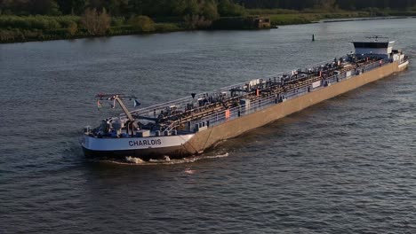 Charlois,-Inland-tanker,-transporting-goods-along-Oude-Maas-river,-aerial