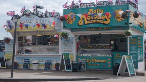 footage-of-Scarborough,-North-Yorkshire-on-a-summer-day-with-two-street-seafood-stalls-selling-seafood