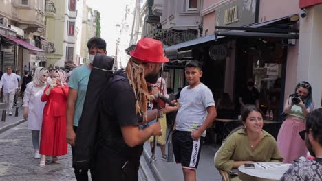 A-bustling-and-crowded-pedestrian-area-with-people-and-street-musicians-in-Istanbul,-Turkey