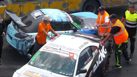 Pushing-manually-one-of-the-crashed-cars-so-they-can-be-removed-from-the-racing-tracks