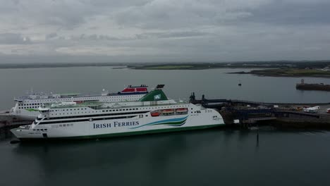 Irish-Ferries-and-Stenaline-docked-passenger-ships-aerial-view-circling-Holyhead-harbour-gateway