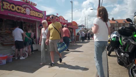 footage-of-Scarboroughsea-side-food-shops,-North-Yorkshire-on-a-summer-day-on-a-busy-weekend-with-people-enjoying-the-English-coastal-seaside-resort