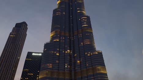 Tilt-up-Burj-Khalifa-skyscraper-illuminated-against-evening-dusk-sky