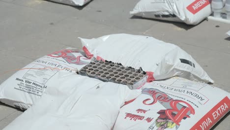 Set-of-firecrackers-surrounded-by-sandbags-after-being-detonated-in-a-Valencian-fireworks-display