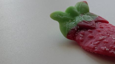 Slow-panning-movement-of-big-strawberry-jelly-on-a-table-in-studio-environment-at-home