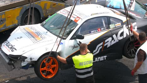 Loading-one-of-the-crashed-cars-so-it-can-be-removed-from-the-racing-tracks