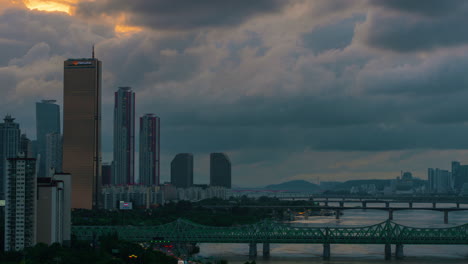 Sunset-Timelapse-with-Dramatic-Clouds-Moving-Above-Yeouido-Financial-District-Skyscrapers-and-63-Building---aerial-view