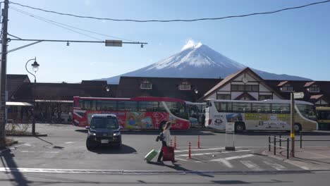 Tourists-walking-in-front-of-the-station-in-Lake-Kawaguchiko-with-Mount-Fuji-in-the-background-in-Japan