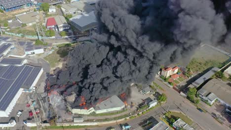 Drone-Captures-Factory-Blaze-Wide-Angle-Zoom-Out-Reveals-Dense-Smoke-and-Flames-Consuming-the-Structure