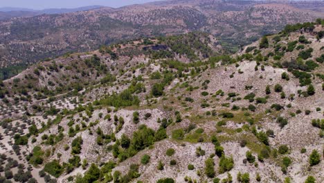 Vista-Aérea-De-Rodas,-Que-Muestra-Montañas-Escarpadas-Y-áreas-De-árboles-Dispersos-En-Grecia.