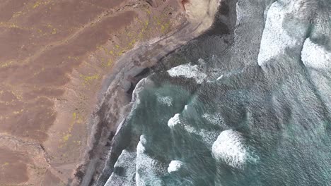 Toma-Aérea-De-Las-Olas-Del-Océano-Rompiendo-En-La-Costa-De-Una-Isla-Volcánica,-Sao-Vicente,-Cabo-Verde,-60-Fps