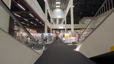 POV-walk-inside-large-hall-with-many-salesman-and-vendor-at-Exhibition-trade-fair-in-Hamburg