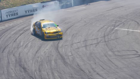 Golden-race-car-drifting-on-a-very-tight-curve-with-lots-of-smoke