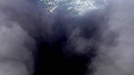 Aerial-drone-shot-within-a-thick-black-smoke-cloud-from-a-burning-factory-in-the-Caribbean